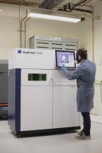 Operator Martin Stroetinga van Fontys bij de 3D metaalprinter (beeld: Fontys)'